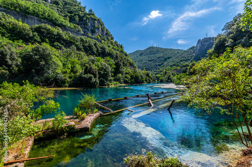 The Roman port of ancient Narnia in Stifone, in the canyons of the Nera river. The blue sky and the clear, cold and turquoise water, on a sunny day in the summer.
