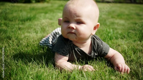 serious kid lying on grass slow motion