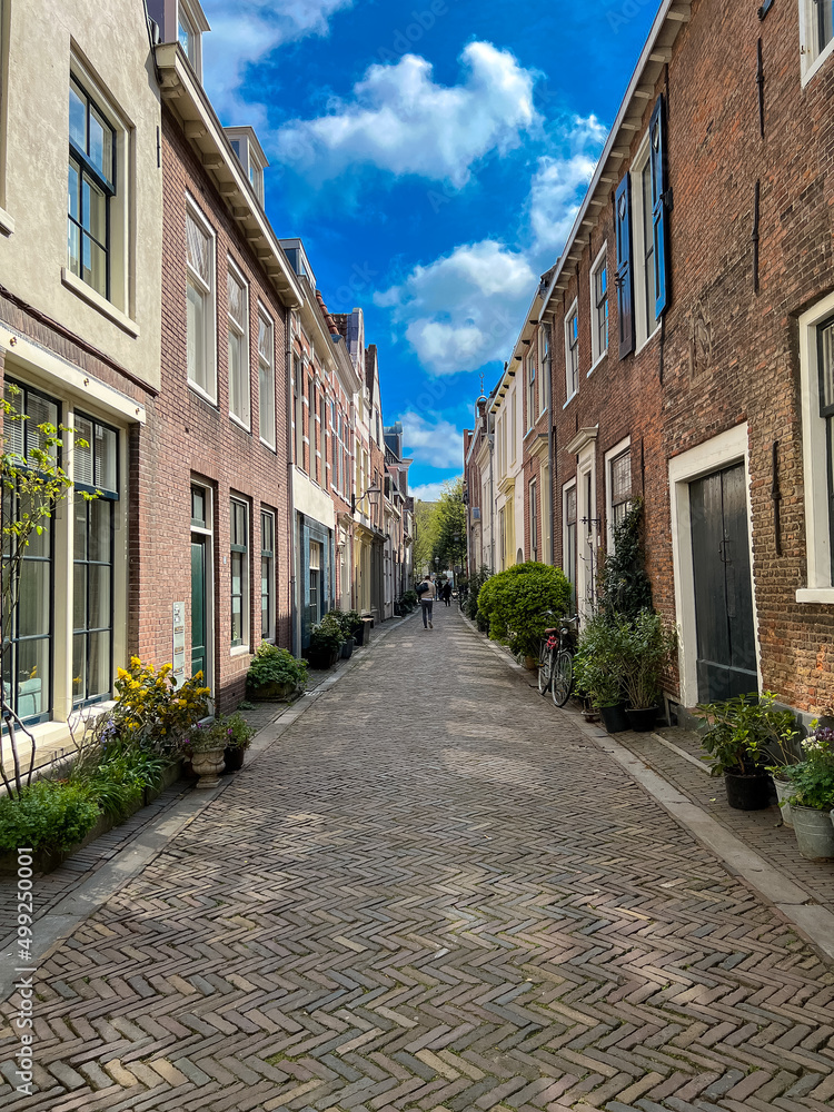 streetview of the city of Haarlem with old houses and a bicycle on a sunny day