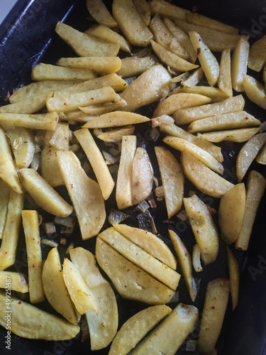 baked potatoes on a baking sheet in spices