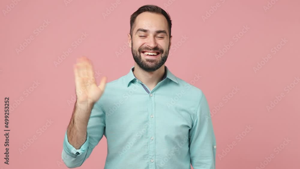 Sleepy happy vivid fancy fascinating charming young brunet man 20s years old wears blue shirt sleep with folded hands under cheek wake up wave hand greet isolated on plain plain pink background studio Sleepy happy vivid fancy fascinating charming young brunet man 20s years old wears blue shirt sleep with folded hands under cheek wake up wave hand greet isolated on plain plain pink background studio