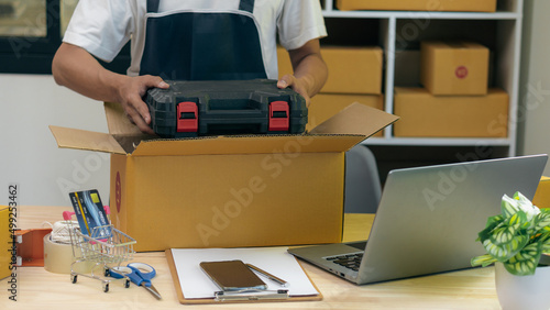 Small Business Startup Asian SME Entrepreneurs Work with Box and Laptop to Take Orders at Home  Office  Warehouse  Online Marketing Package Delivery. E-commerce parcel delivery concept
