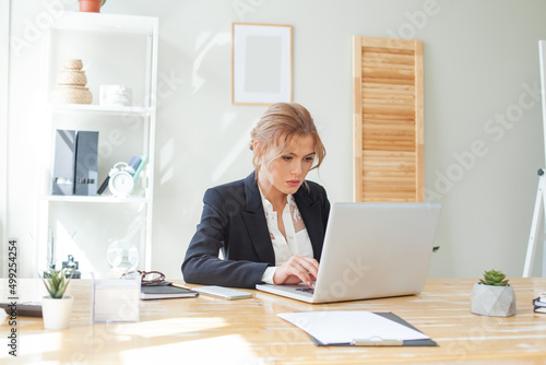 Smart businesswoman using laptop in the workspace