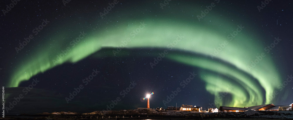 Aurora Borealis over the Atlantic Ocean and the Andenes' lighthouse