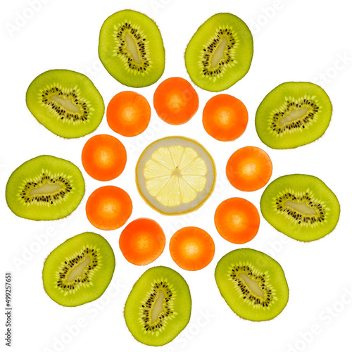 Close up of slices of green kiwi  orange carrots  yellow lemon  transparent as a background