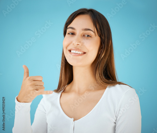 Wallpaper Mural Call me. Studio shot of a young woman holding her hand out and showing the hang ten sign. Torontodigital.ca