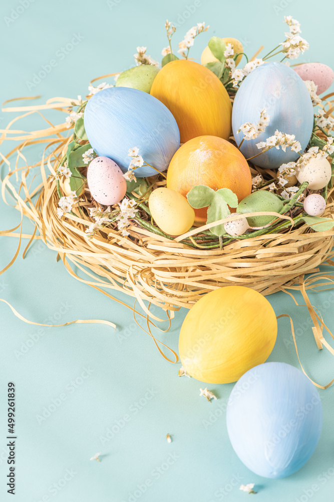 Obraz premium Easter blue and yellow eggs in nest