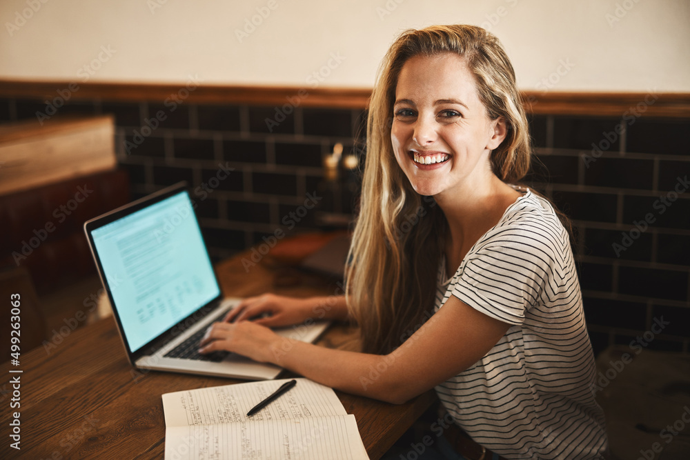 This is my favorite study spot. Portrait of a happy young student using her laptop to study at a cafe table. This is my favorite study spot. Portrait of a happy young student using her laptop to study at a cafe table.