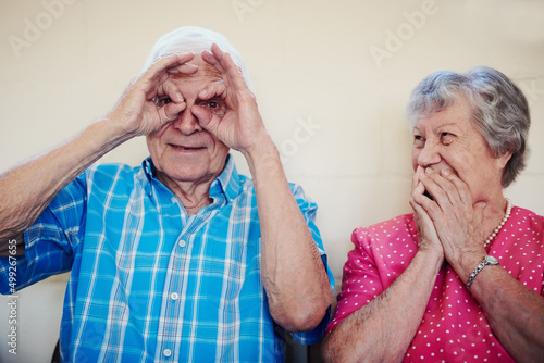 Time brought us so much happiness. Shot of a senior couple making funny faces outside. photo