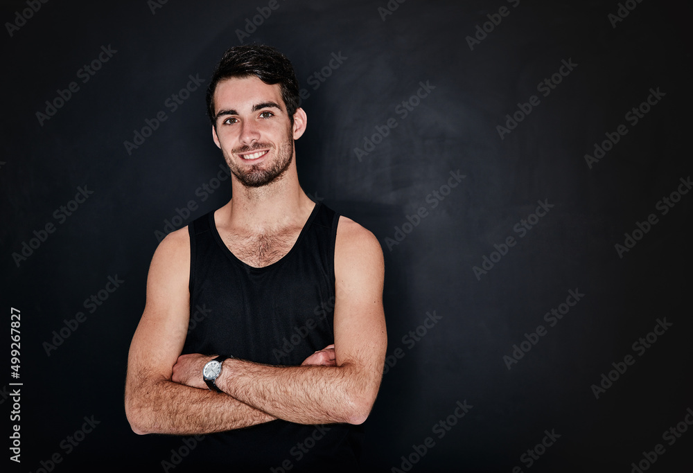 Healthy is the only option. Studio portrait of a fit and confident young man posing against a gray background.
