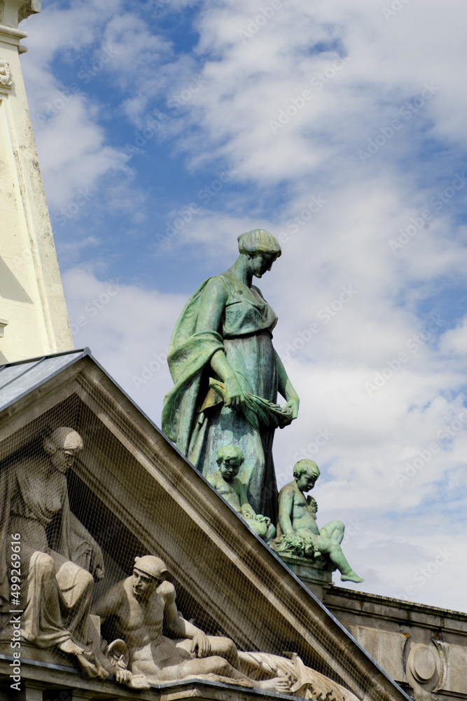 Fototapeta premium pediment and statue in the roof of the Banco de Portugal building on the Avenida dos Aliados in Porto, Portugal