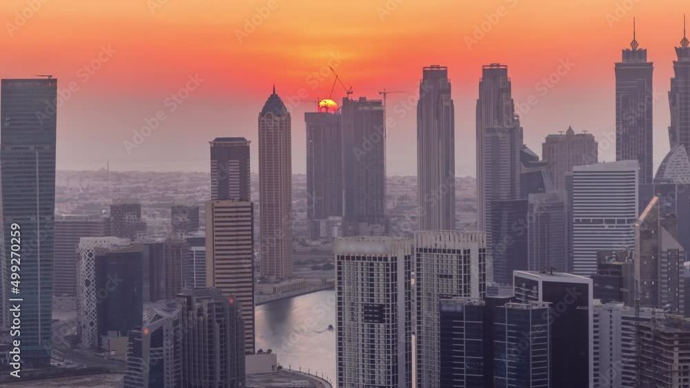 Skyline with modern architecture of Dubai business bay towers at sunset timelapse. Aerial view Skyline with modern architecture of Dubai business bay towers at sunset timelapse. Aerial view