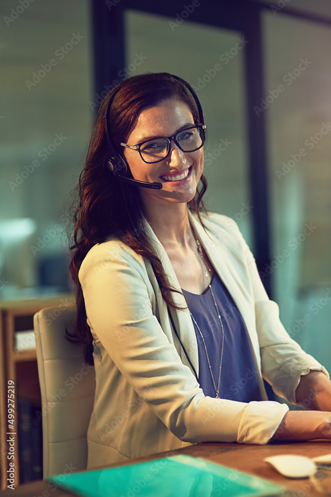 Im on call for the night shift. Portrait of a young support agent working late in an office. Im on call for the night shift. Portrait of a young support agent working late in an office.