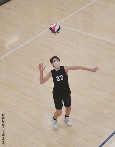 Volleyball player serving the ball overhand