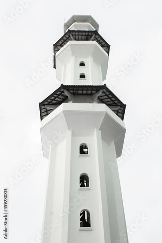 White mosque minaret with cloudy weather
