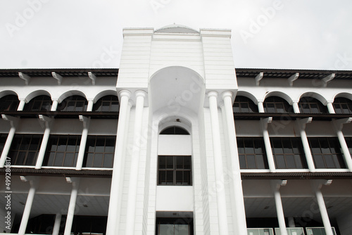 The mosque building is white with a high gate