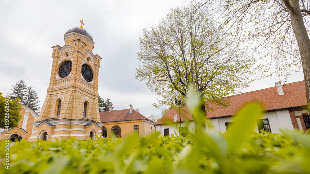 Church Hram trojice in Kragujevac, Serbian city on a cloudy day. Frog view of belltower of orthodox church.