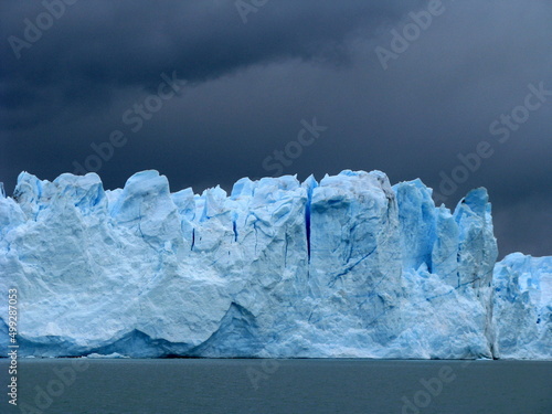 Blue ice of Perito Moreno glacier in Patagonia Argentina near El Calafate with dark sky. High quality photo