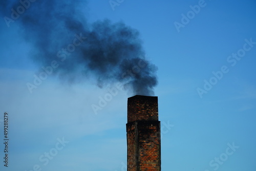 Old factory chimney of a brickyard in Amazon region of Brazil. The circular kiln is operated with tropical wood and all materials that burn. The smoke is black and pollutes the air. Manaus, Brazil.