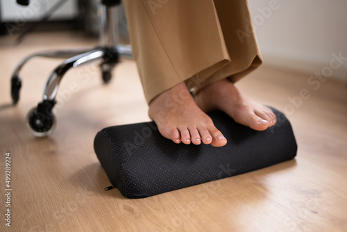 Worker Using Footrest To Reduce Back Strain photo