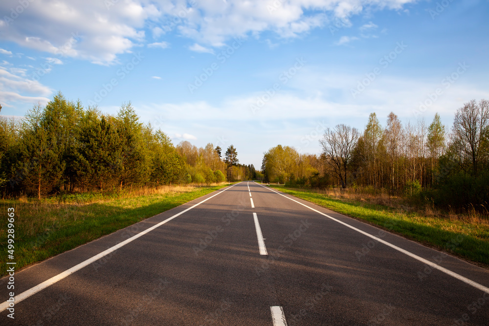 an empty paved road in the countryside an empty paved road in the countryside