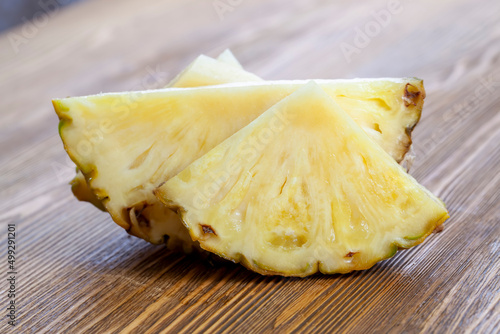 cut into pieces ripe yellow pineapple on the table