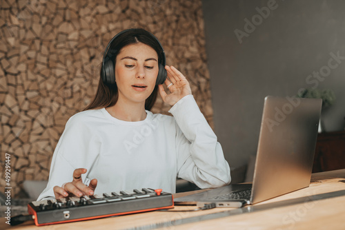 girl creation and listen music in grey headphones