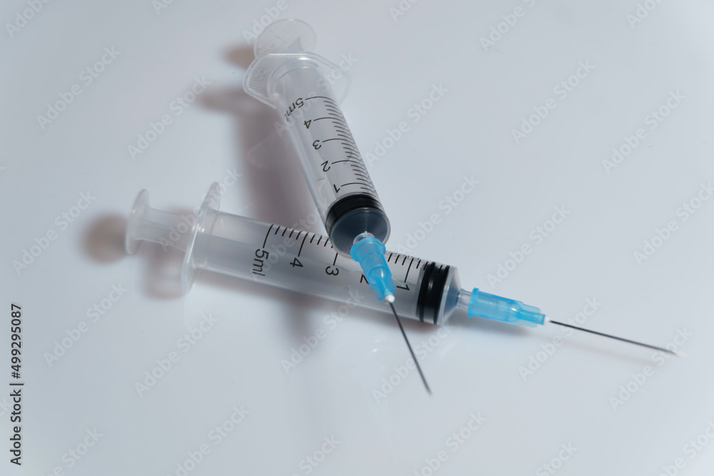 Medical syringe on a white background. A syringe for injection. The concept of health and beauty Medical syringe on a white background. A syringe for injection. The concept of health and beauty