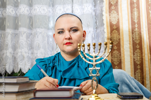 The female rabbi of a progressive congregation, shaved bald in the clip, makes a plan of action.
