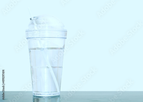 plastic cup with water and straw