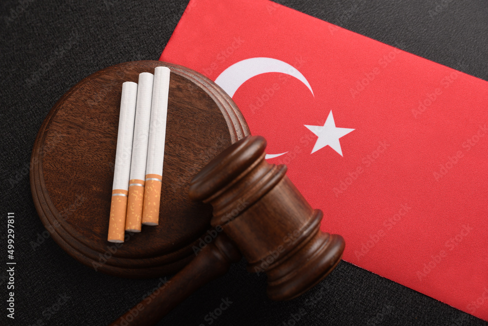 Cigarettes, wooden Judge gavel and flag of Turkey. Top view. Justice and Tobacco law. Tobacco control act. Government duty. Illegal import.