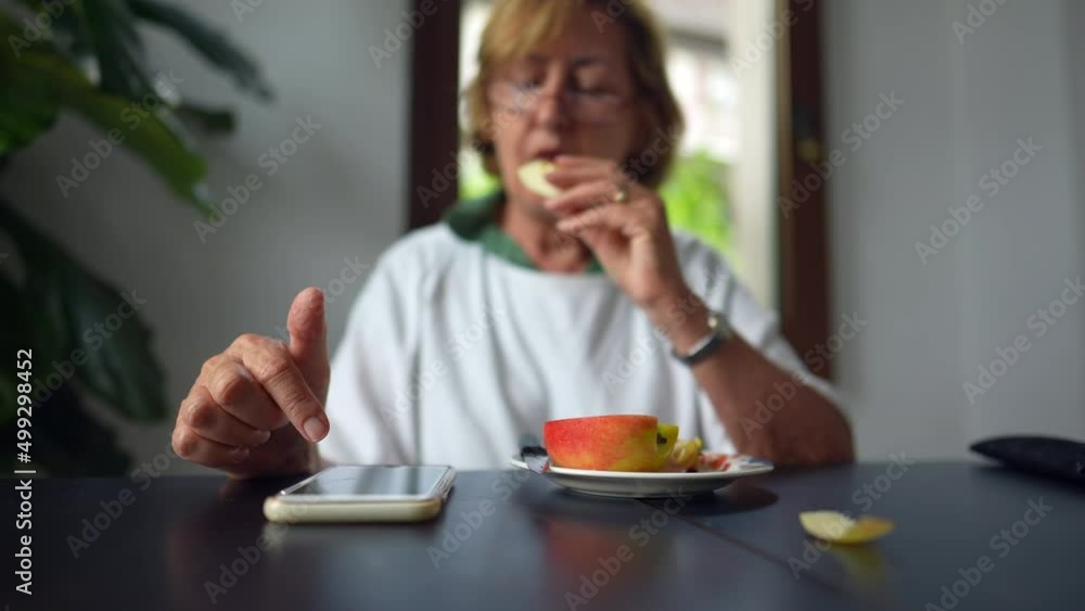 An older woman using cellphone device at home a senior person uses smartphone An older woman using cellphone device at home a senior person uses smartphone