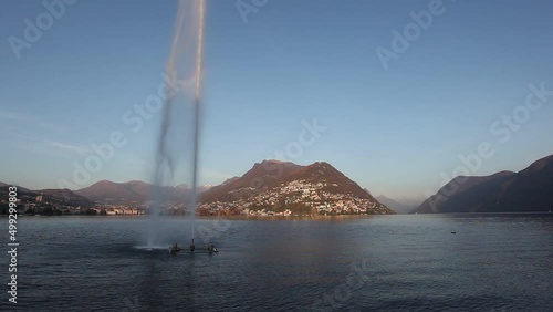 Big water fountain in lake Lugano at sunset, Switzerland. High quality FullHD footage