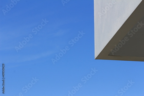 White architecture of building with light and blue sky.. Walls on the roof with Sky.
