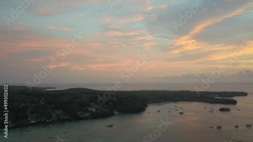 Buttery soft 120m high aerial view flight slowly circle drone footage
golden hour dream sunset with colourful clouds at Mushroom Bay Lembongan. Cinematic view from above by Philipp Marnitz summer 2017 photo