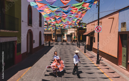 Aerial photo of dancers of typical Mexican dances from the downtown region, doing their performance in the street adorned with bandanas. photo