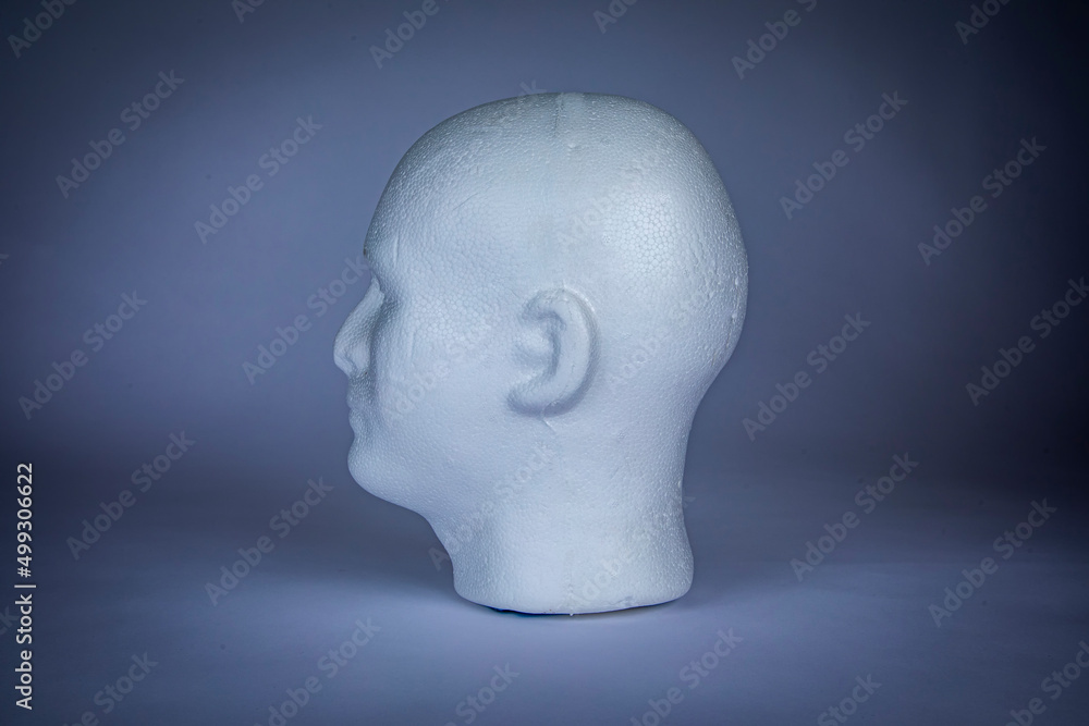 White styrofoam male head looking left on isolated on background White styrofoam male head looking left on isolated on background