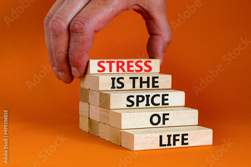 Stress spice of life symbol. Concept words Stress is the spice of life on wooden blocks. Businessman hand. Beautiful orange background. Business motivational stress spice of life concept. Copy space. photo