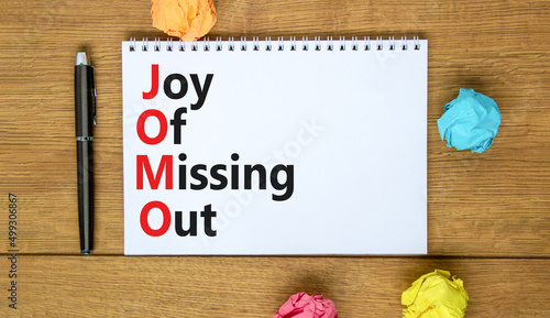 JOMO joy of missing out symbol. Concept words JOMO joy of missing out on the note on a beautiful white background. Business JOMO joy of missing out concept. Copy space.