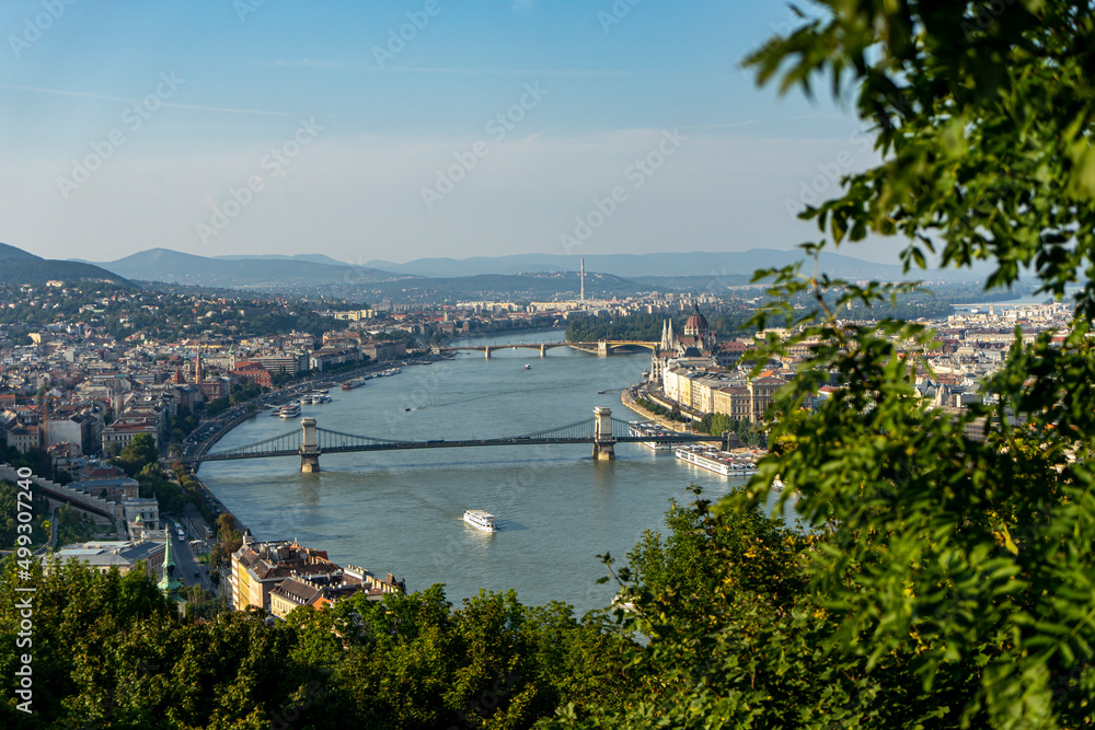 Selective focus on the view of the Danube and Gellert Hill Szechenyi Chain Bridge and the Hungarian Parliament in Budapest