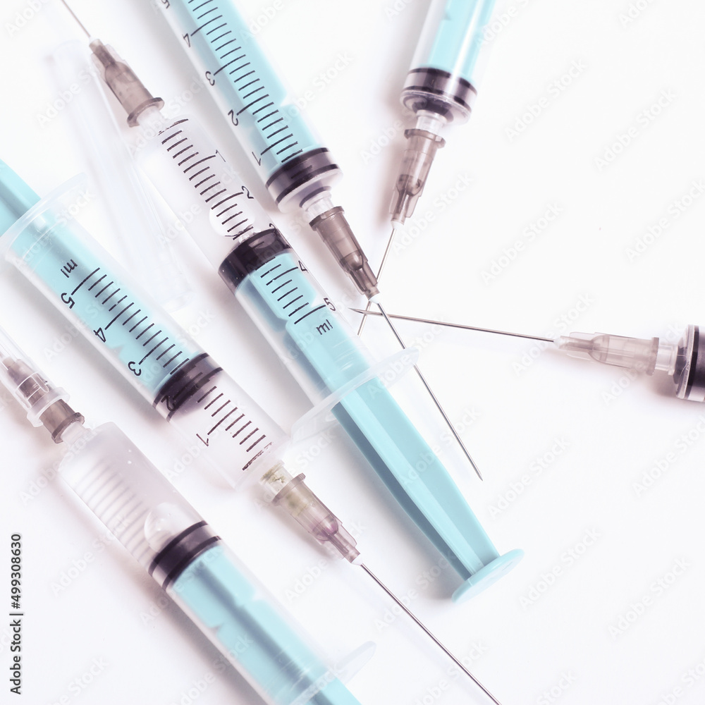 Medical syringe on a white background. A syringe for injection. The concept of health and beauty Medical syringe on a white background. A syringe for injection. The concept of health and beauty