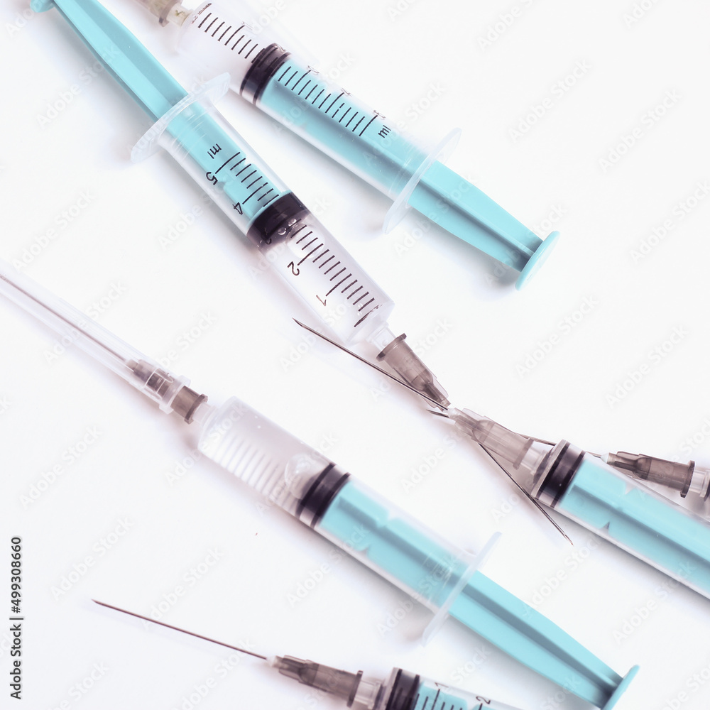 Medical syringe on a white background. A syringe for injection. The concept of health and beauty Medical syringe on a white background. A syringe for injection. The concept of health and beauty