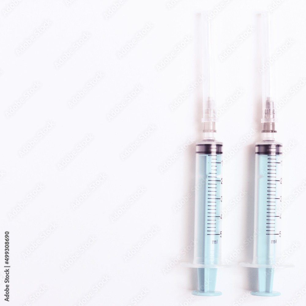 Medical syringe on a white background. A syringe for injection. The concept of health and beauty Medical syringe on a white background. A syringe for injection. The concept of health and beauty