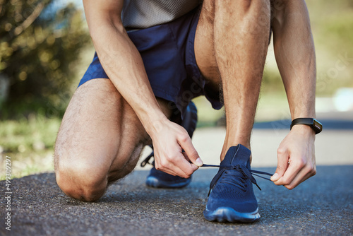 People with goals succeed because they know where theyre going. Closeup shot of an unrecognisable man tying his shoelaces while exercising outdoors.
