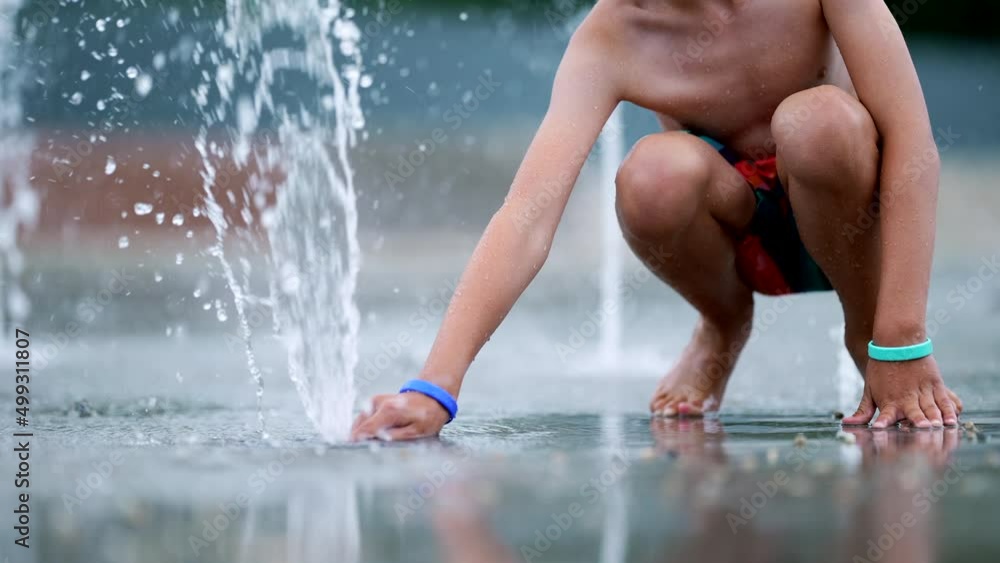Child plays public water faucet making water pressure