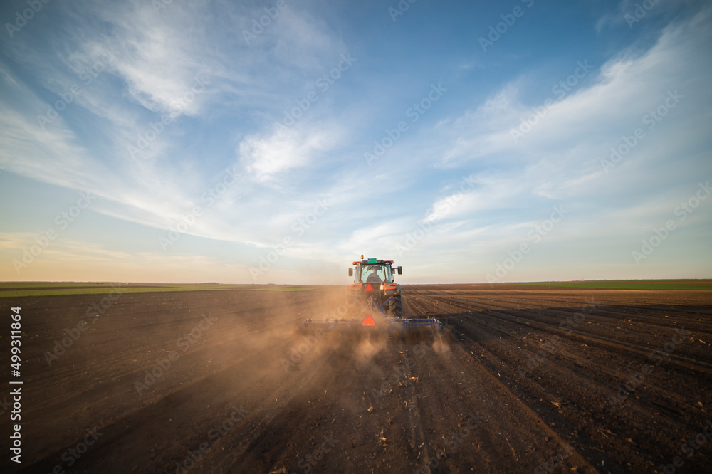 Fototapeta premium Tractor working in the field