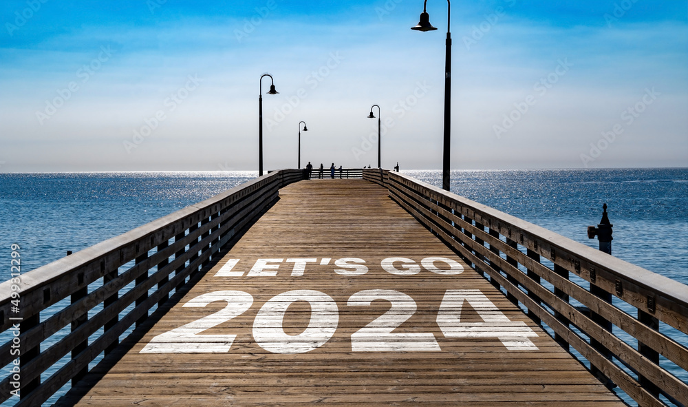 Plakat Let's Go 2024 written on the wooden planks of a pier on the