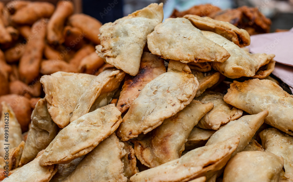 A pile of indian fried cakes close up shot on a street market A pile of indian fried cakes close up shot on a street market