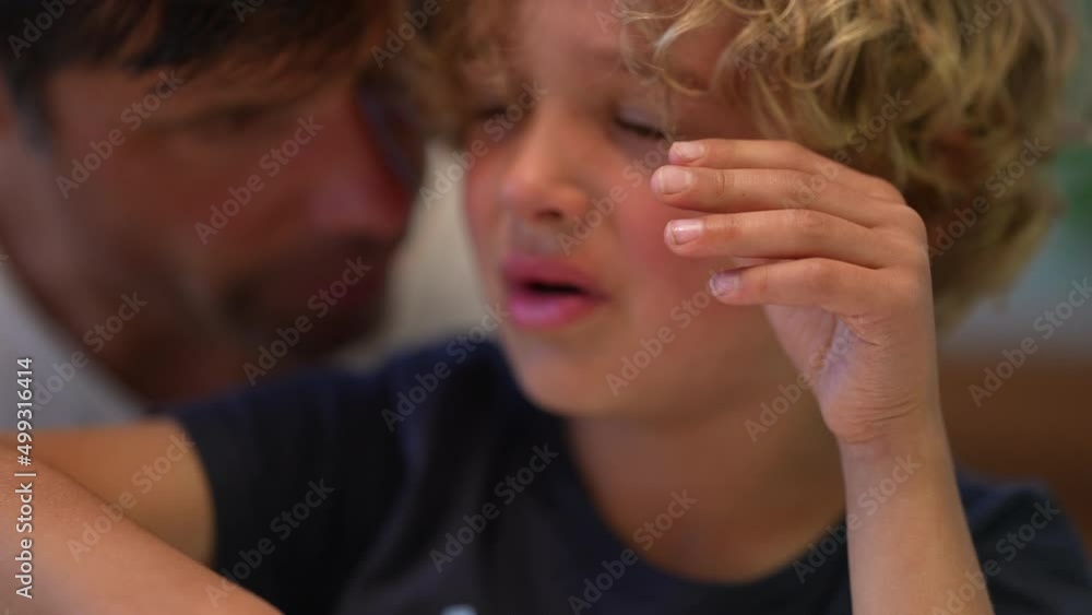 Tearful little boy crying father consoling child Tearful little boy crying father consoling child