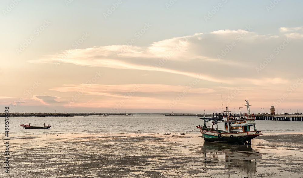 Panorama of the evening atmosphere.A fishing boat stuck on the rocks on Ang Sila Market